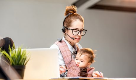 Businesswoman working with her baby son at the office